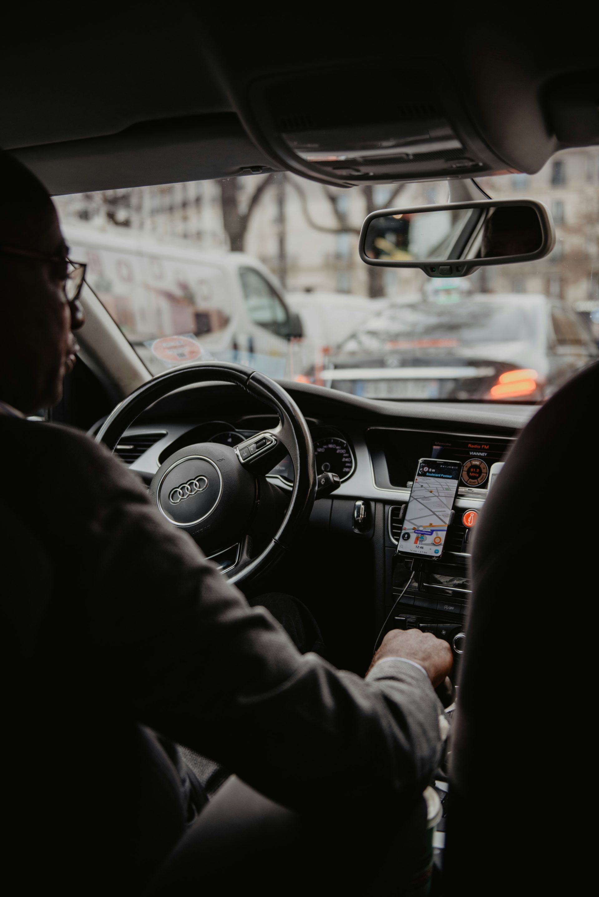 man in black jacket driving car during daytime